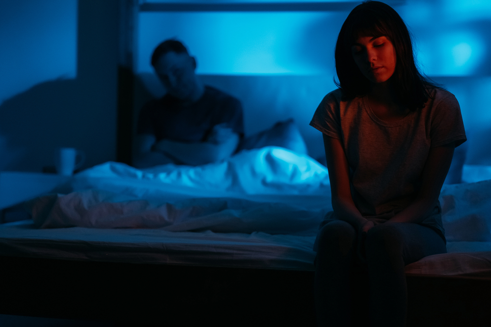 unhappy-couple-in-a-dark-bedroom