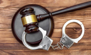 gavel stand with handcuffs on table