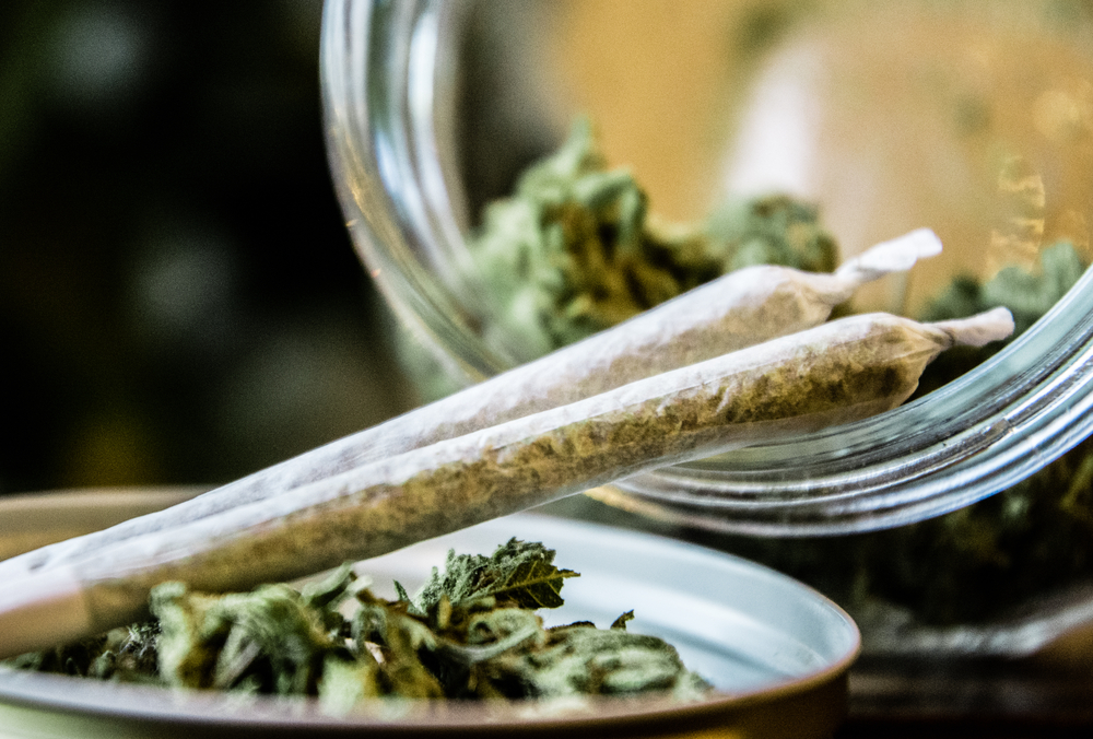 marijuana joints next to a jar