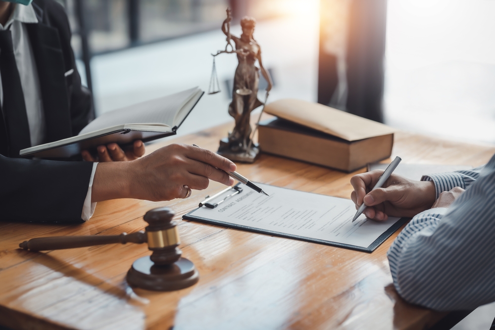 A Rowlett criminal defense lawyer talking to a client.