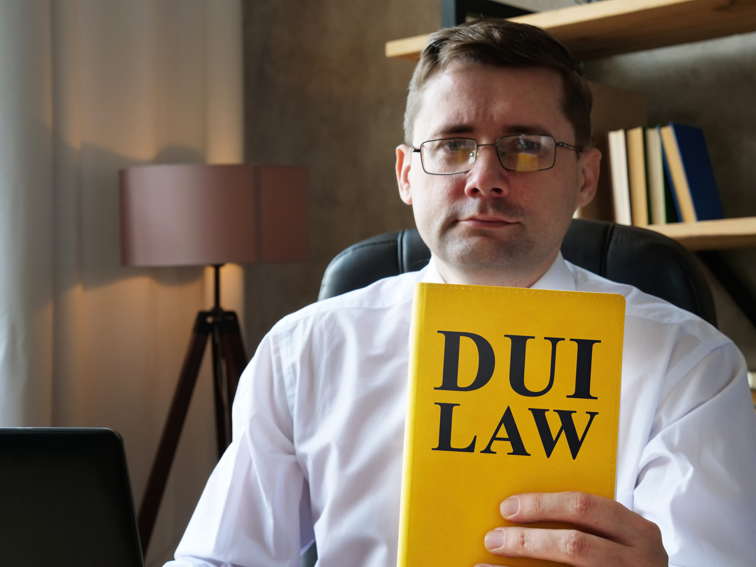 A Glenn Heights DWI lawyer holding up a book that says “DUI Law”