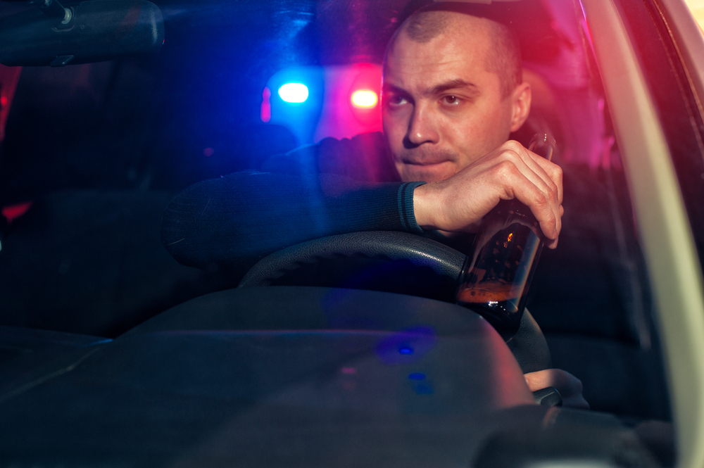 An impaired driver is holding an open alcohol bottle while being chased by police. To escape harsh penalties, the help of a Fort Worth DUI lawyer is necessary.